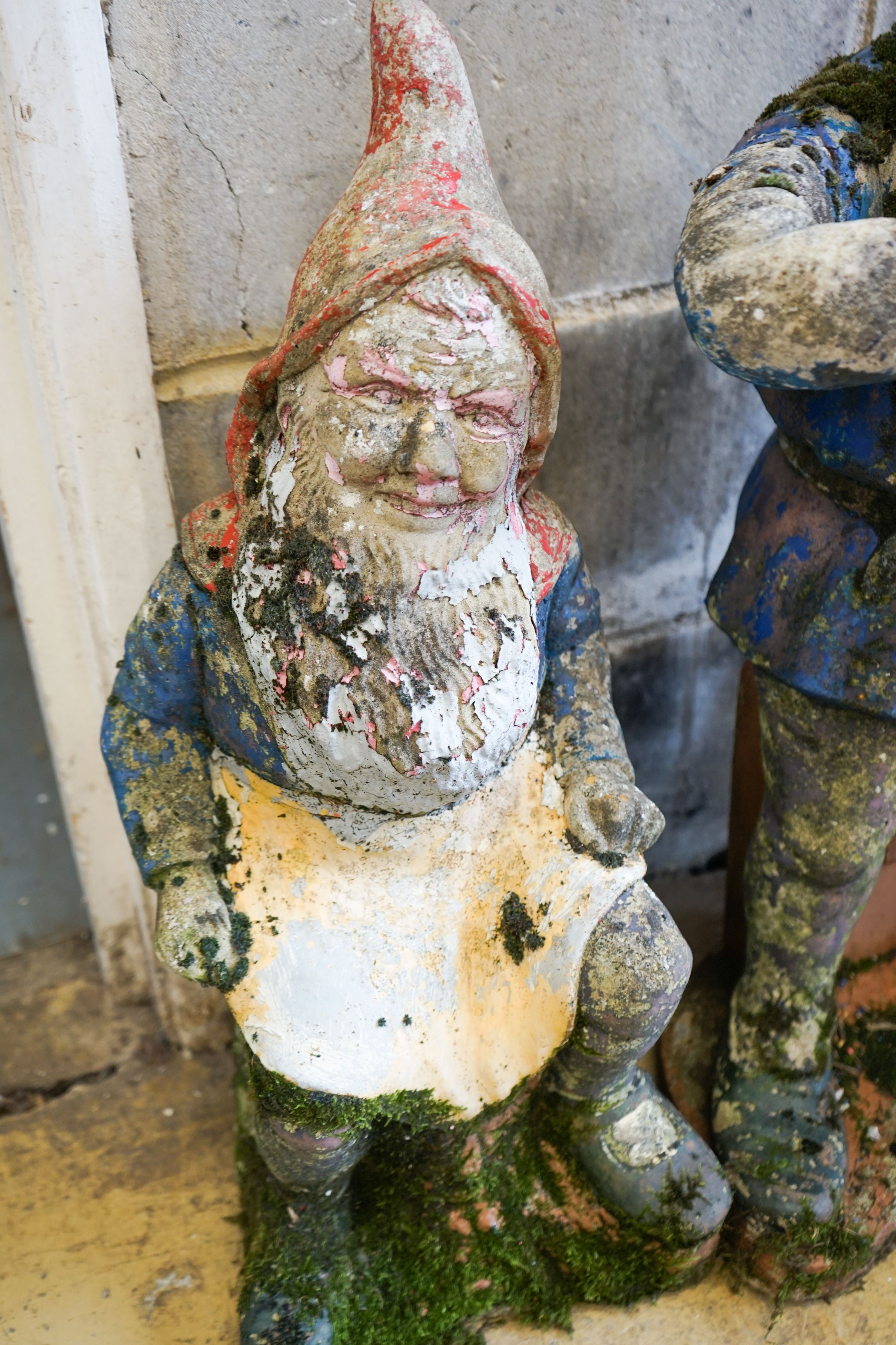 Two painted reconstituted stone garden gnome ornaments, larger height 90cm